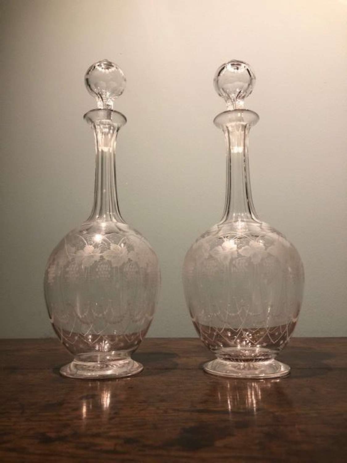 A PRETTY PAIR OF 19TH C. ENGRAVED DECANTERS