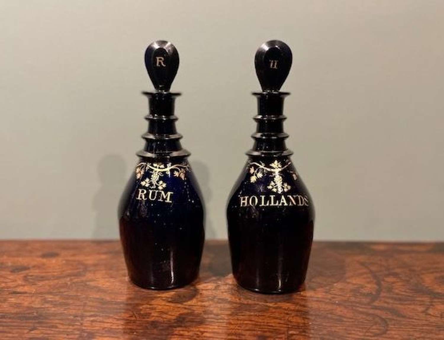 A pair of Regency 'Bristol blue' spirit decanters - Rum and Hollands